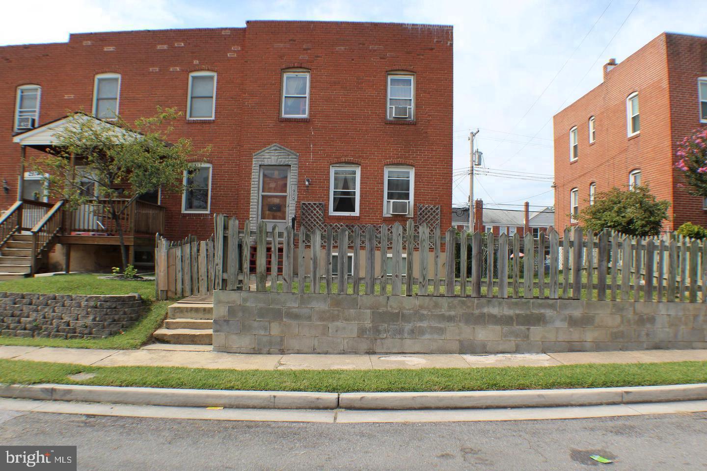 a view of a brick building next to a yard