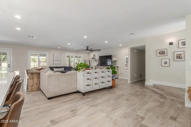 a kitchen with kitchen island stainless steel appliances a stove sink microwave and cabinets