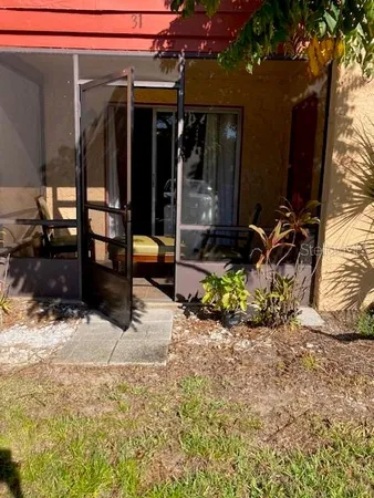 a view of a porch with a table and chairs