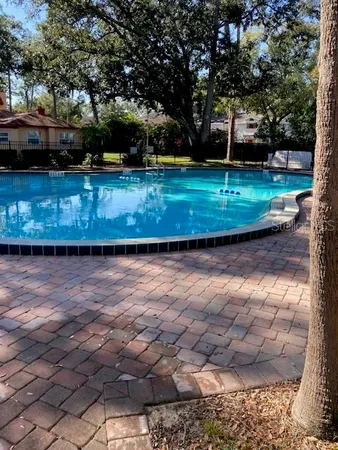 a view of a backyard with swimming pool