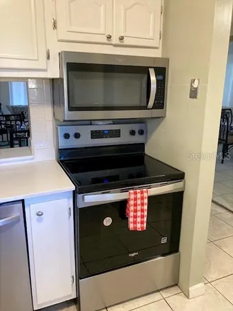 a stove top oven sitting inside of a kitchen