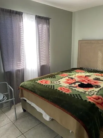 a bedroom with a bed and window