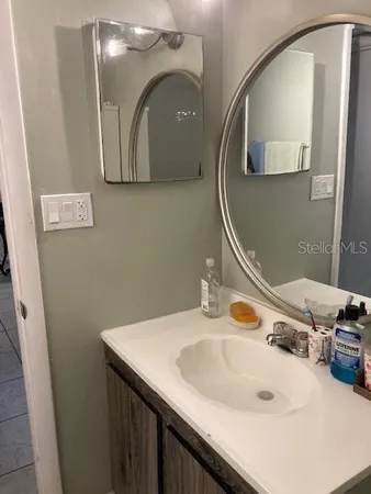 a bathroom with a sink and a mirror