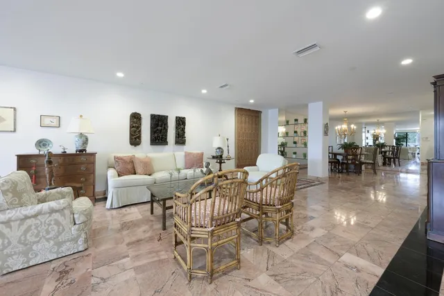 a living room with furniture and a dining table with kitchen view