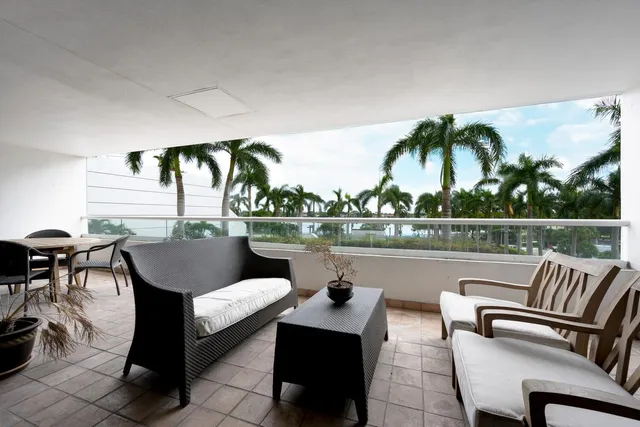 a balcony with furniture and view of lake
