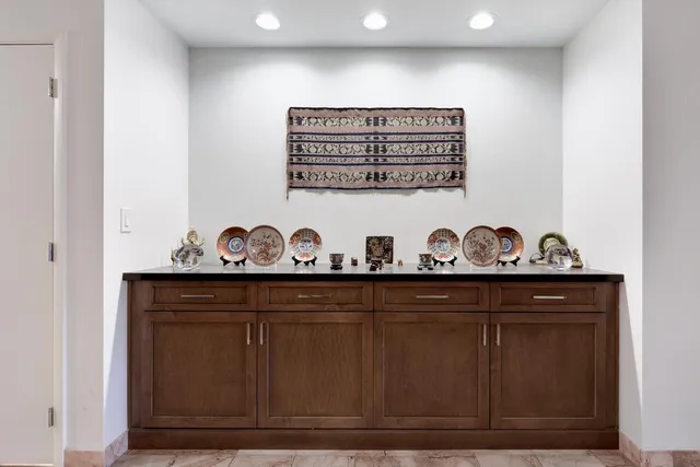 a view of a hallway with wooden cabinets