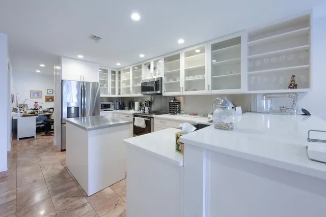 a kitchen with a sink stainless steel appliances and cabinets