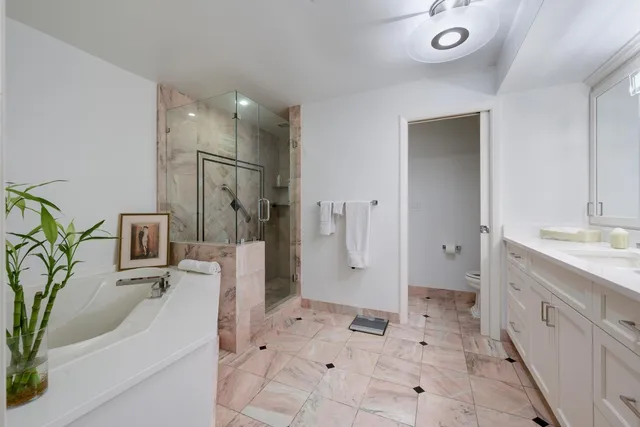 a bathroom with a tub sink and mirror