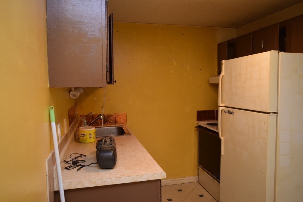 16 Leonard Road, Unit 16 Boxborough, MA 01719 - Photo 11 of 16 a kitchen with a refrigerator and a sink