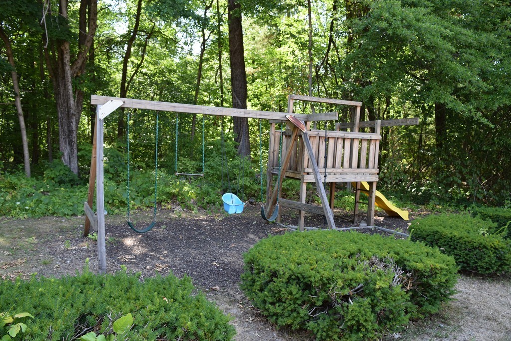 16 Leonard Road, Unit 16 Boxborough, MA 01719 - Photo 8 of 16 a view of a chair and table in the garden