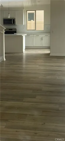 a view of kitchen and empty room