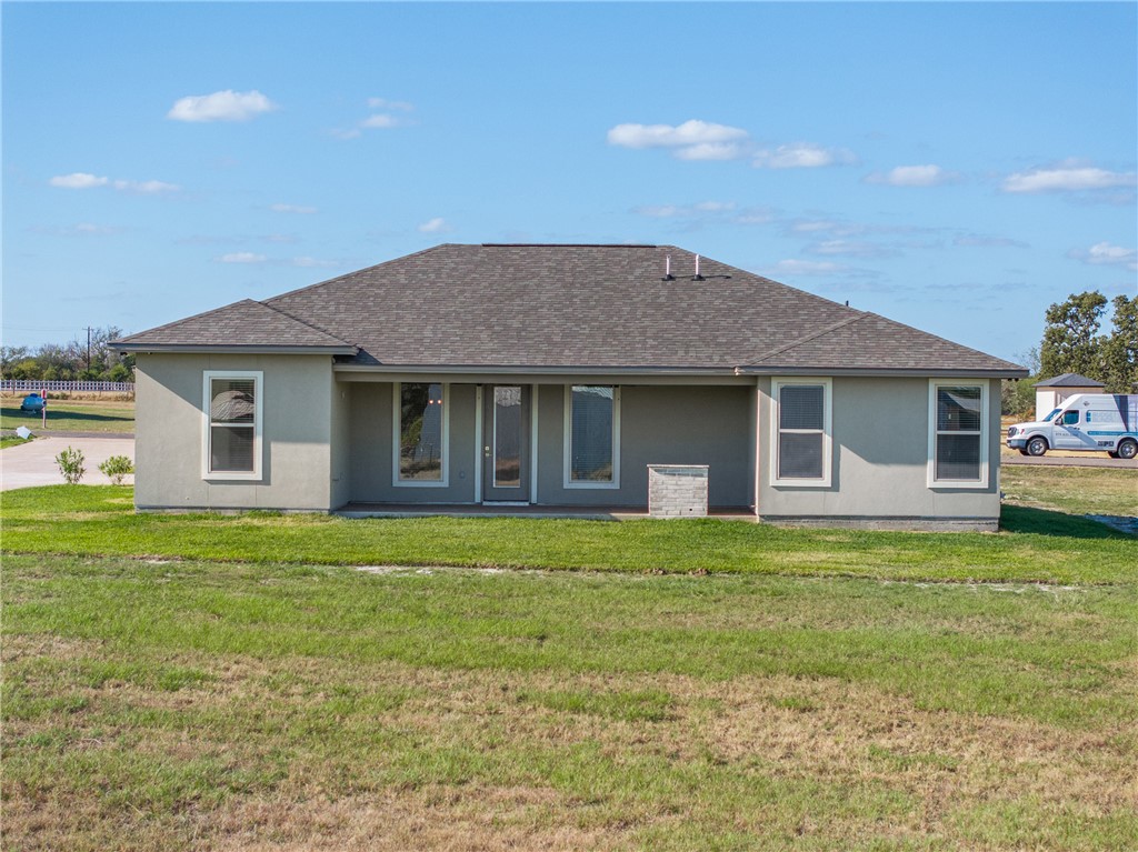 6512 Agave Court Bryan, TX 77808 - Photo 6 of 42 Rear view of house featuring a yard and roof with shingles