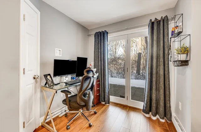 a view of a workspace with furniture and wooden floor
