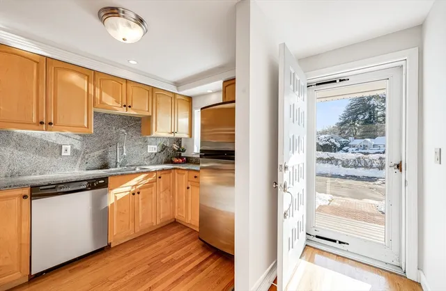 a kitchen with stainless steel appliances granite countertop a refrigerator and a sink
