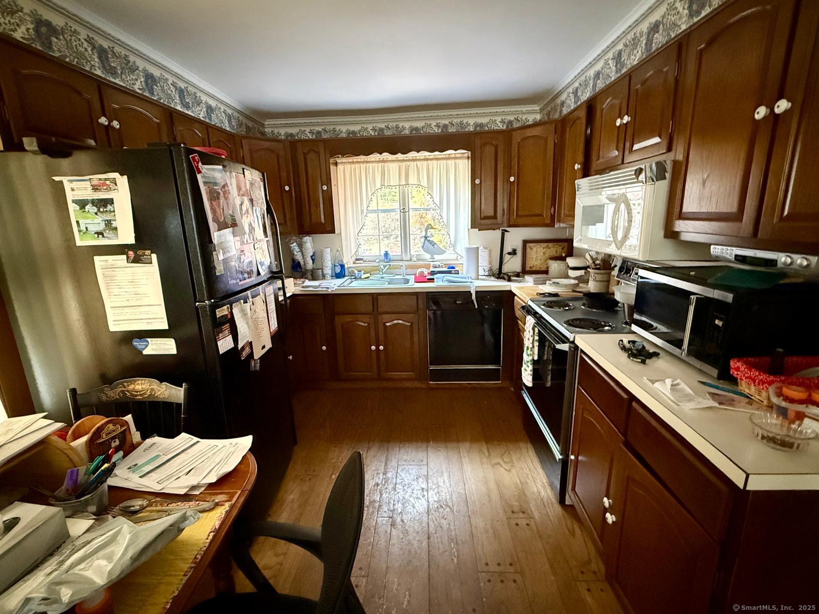 79 Summit Road Prospect, CT 06712 - Photo 11 of 28 a kitchen with wooden floors and appliances