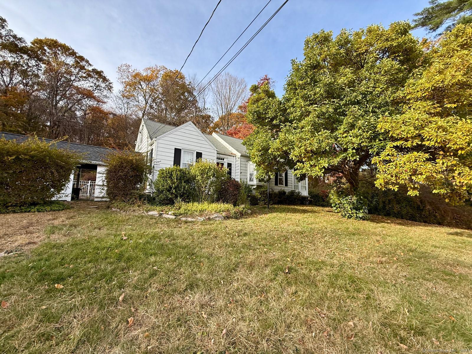 79 Summit Road Prospect, CT 06712 - Photo 3 of 28 a front view of a house with a yard and garage
