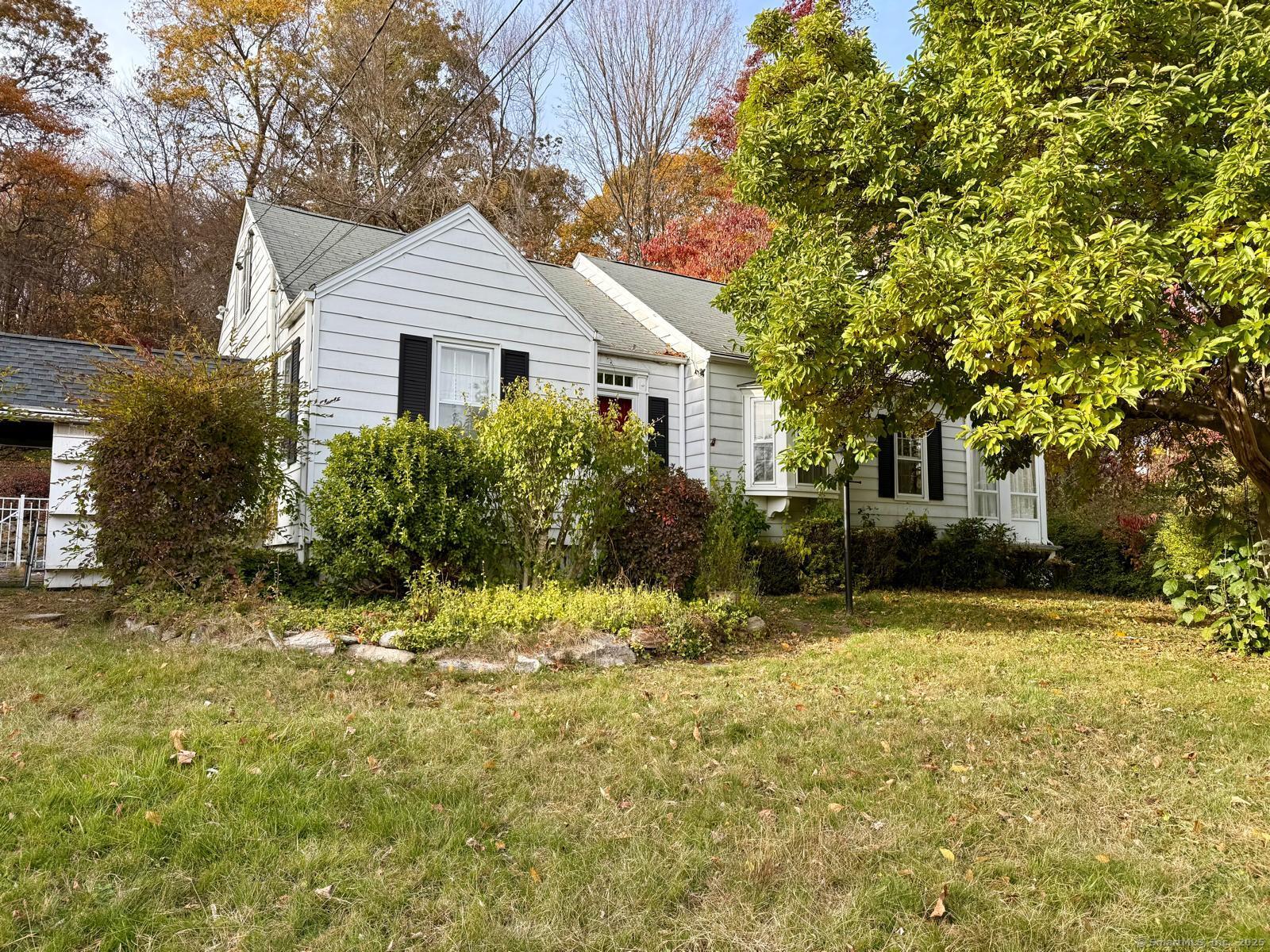 79 Summit Road Prospect, CT 06712 - Photo 4 of 28 a front view of a house with a yard and garage
