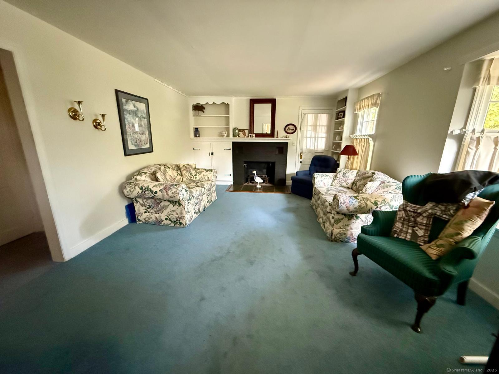 79 Summit Road Prospect, CT 06712 - Photo 8 of 28 a living room with furniture and a fireplace