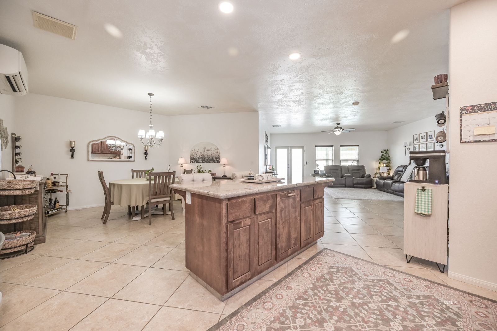 400 Acacia Street Ridgecrest, CA 93555 - Photo 10 of 45 a kitchen with stainless steel appliances kitchen island granite countertop a refrigerator a stove a sink and a dining table with wooden floor
