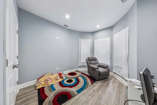 a spacious bedroom with a bed and a dresser