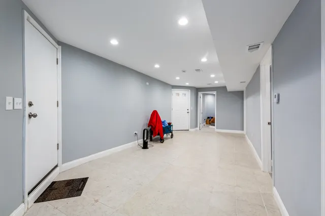 a kitchen with a sink white cabinets and white appliances
