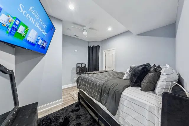 a bedroom with a bed and wooden floor