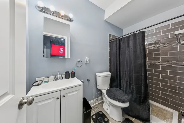 a bathroom with a sink toilet and shower