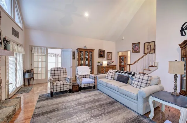 a living room with furniture and hard wood flooring