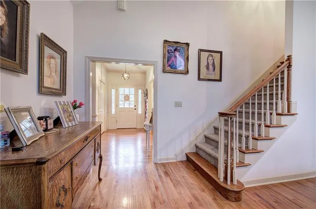 a view of a livingroom with wooden floor and stairs