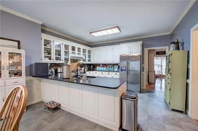 a kitchen with refrigerator and cabinets