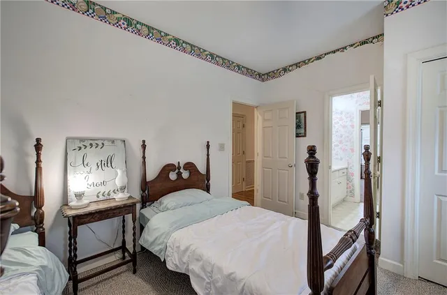 a bedroom with a bed and a mirror