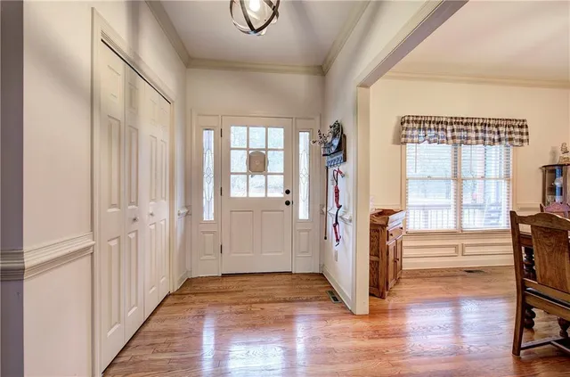 a view of entryway with wooden floor and stairs