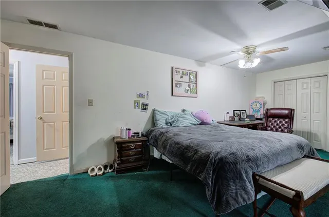a bedroom with bed and a chandelier