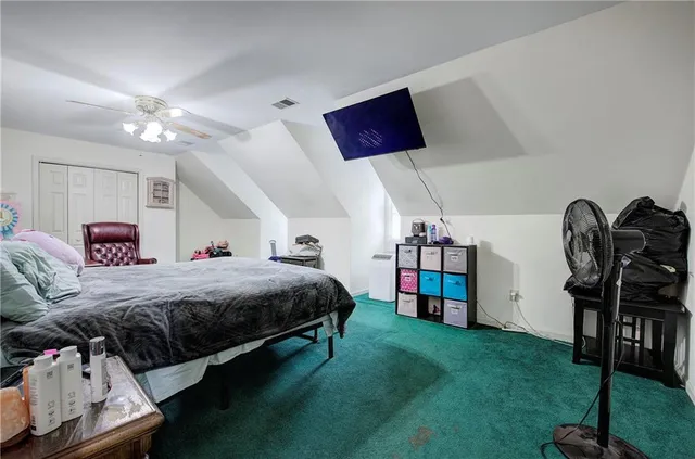 a bed room with a bed and a television
