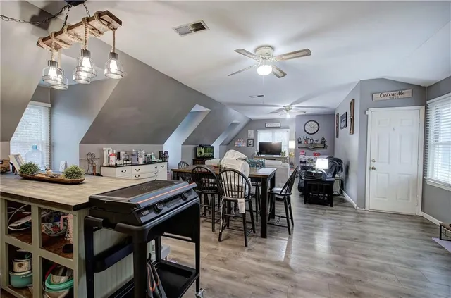 a view of a dining room with furniture and wooden floor