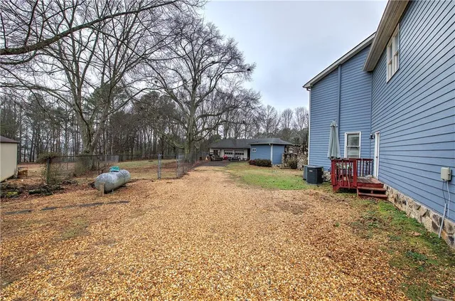 a view of a patio with a table and chairs under an umbrella