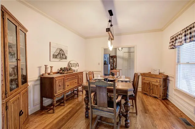 a view of a dining room with furniture window and wooden floor