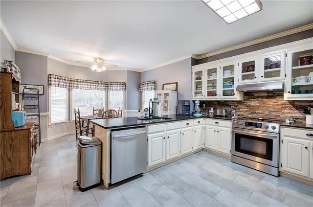 a kitchen with stainless steel appliances granite countertop a stove and a sink