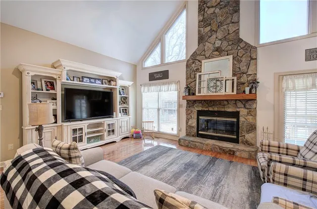 a living room with furniture flat screen tv and a fireplace