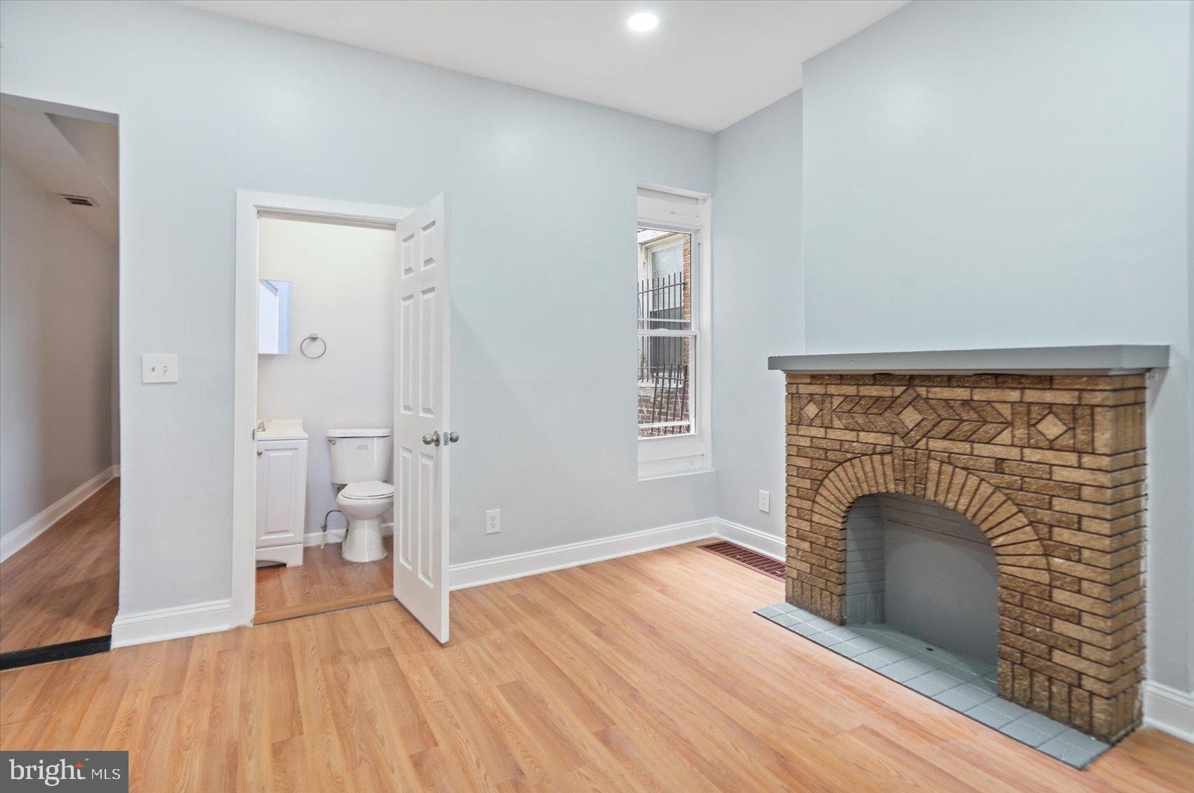 1604 North Broadway Baltimore, MD 21213 - Photo 11 of 39 a view of livingroom with furniture wooden floor fireplace and windows