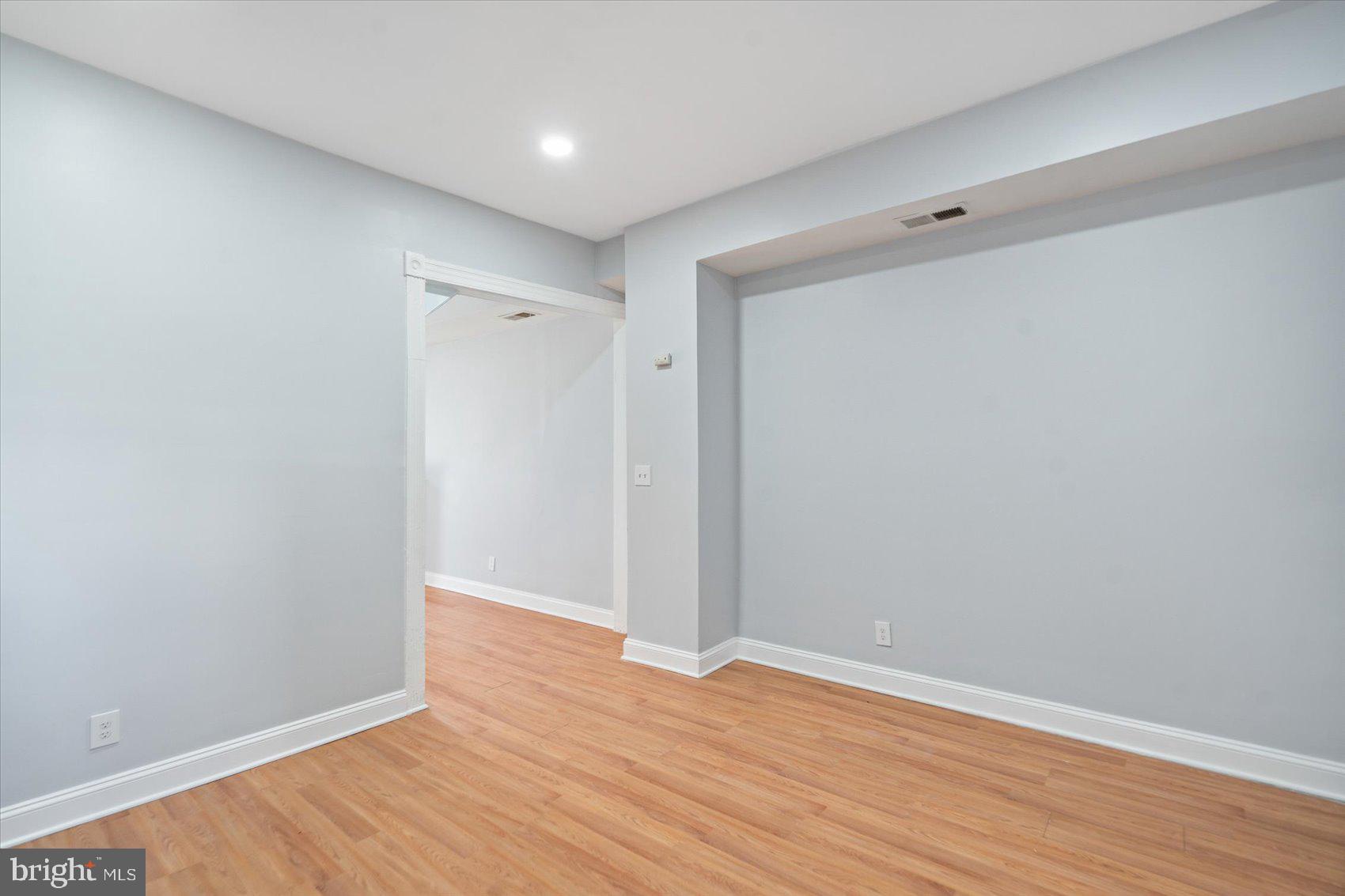 1604 North Broadway Baltimore, MD 21213 - Photo 13 of 39 a view of an empty room with wooden floor