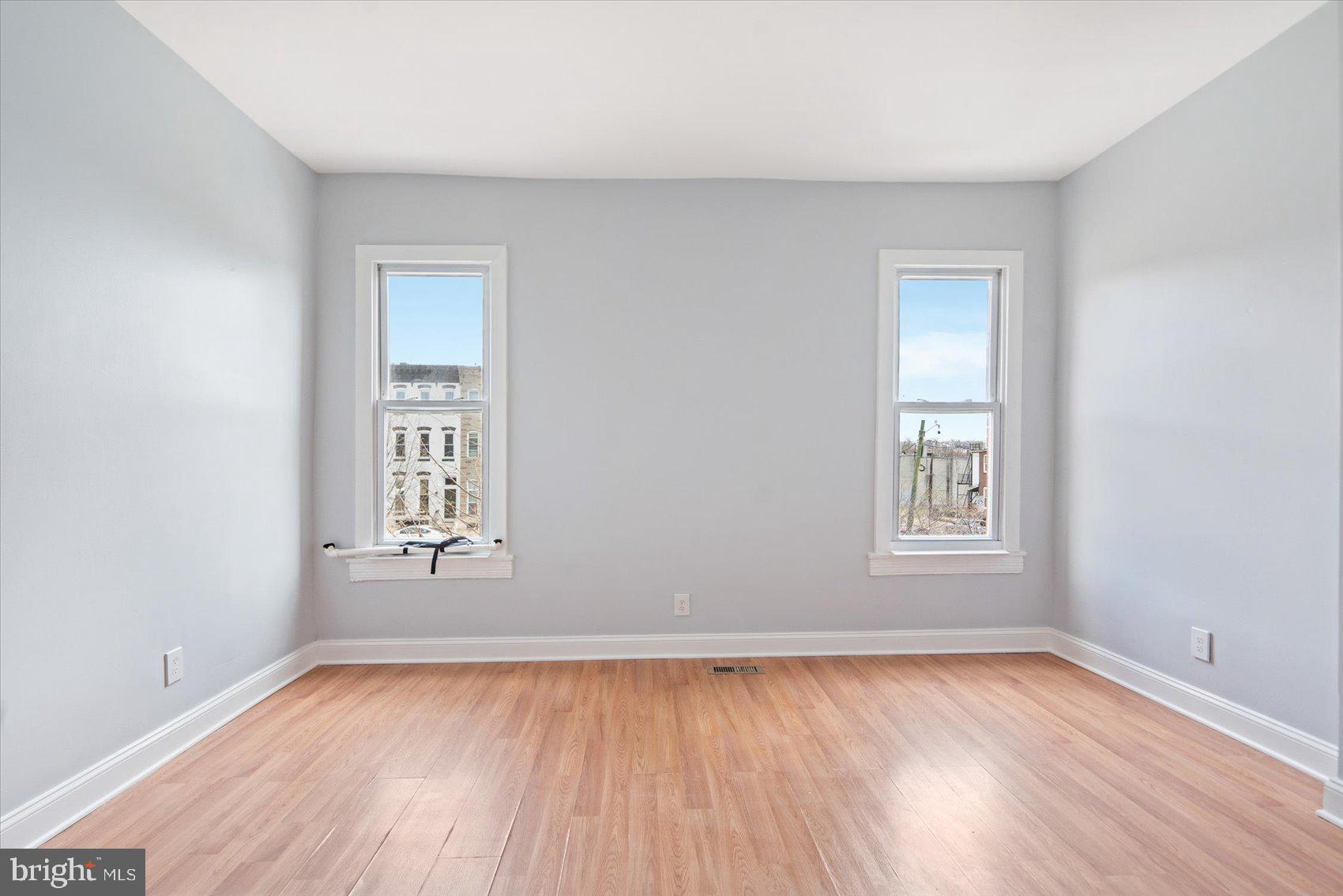 1604 North Broadway Baltimore, MD 21213 - Photo 20 of 39 an empty room with wooden floor and windows