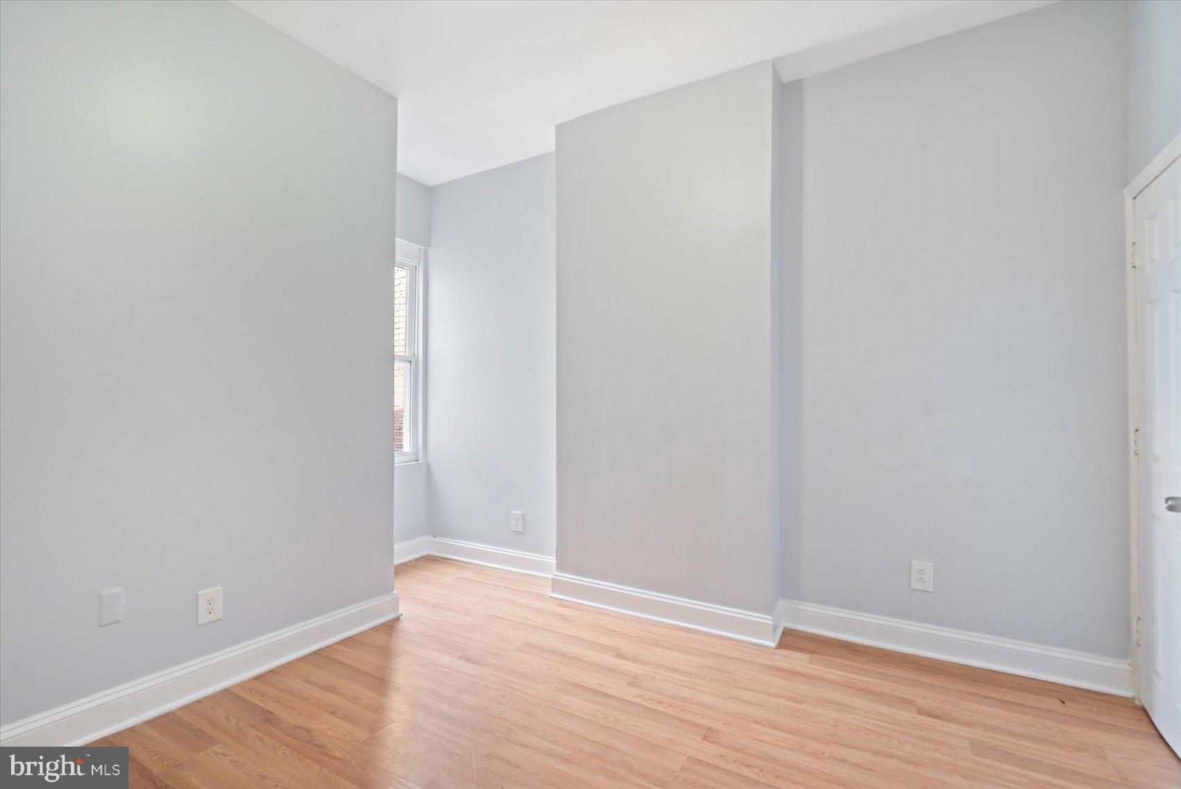1604 North Broadway Baltimore, MD 21213 - Photo 22 of 39 a view of an empty room with wooden floor