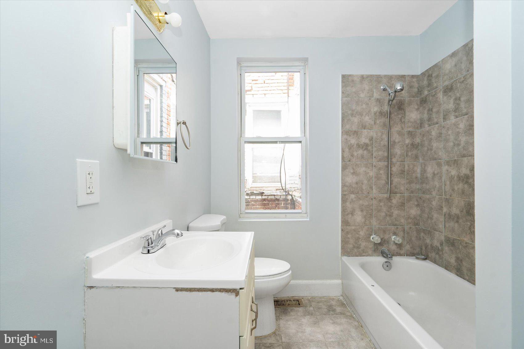1604 North Broadway Baltimore, MD 21213 - Photo 24 of 39 a bathroom with a sink toilet bathtub and vanity