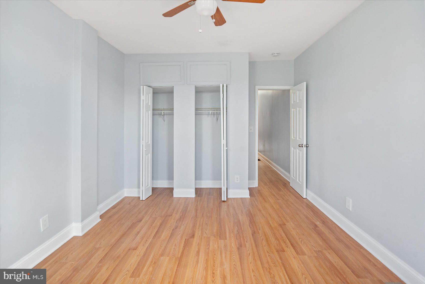1604 North Broadway Baltimore, MD 21213 - Photo 28 of 39 an empty room with wooden floor and windows