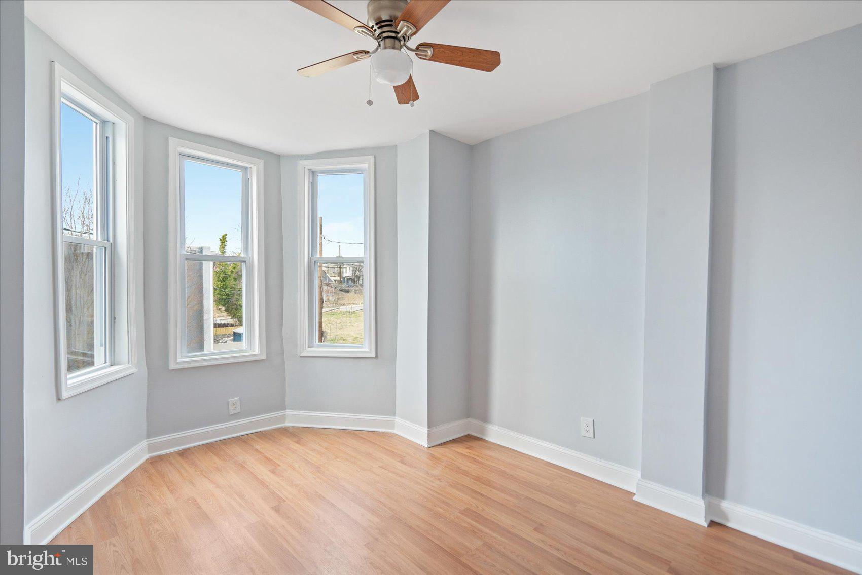 1604 North Broadway Baltimore, MD 21213 - Photo 29 of 39 a view of an empty room with a window and wooden floor