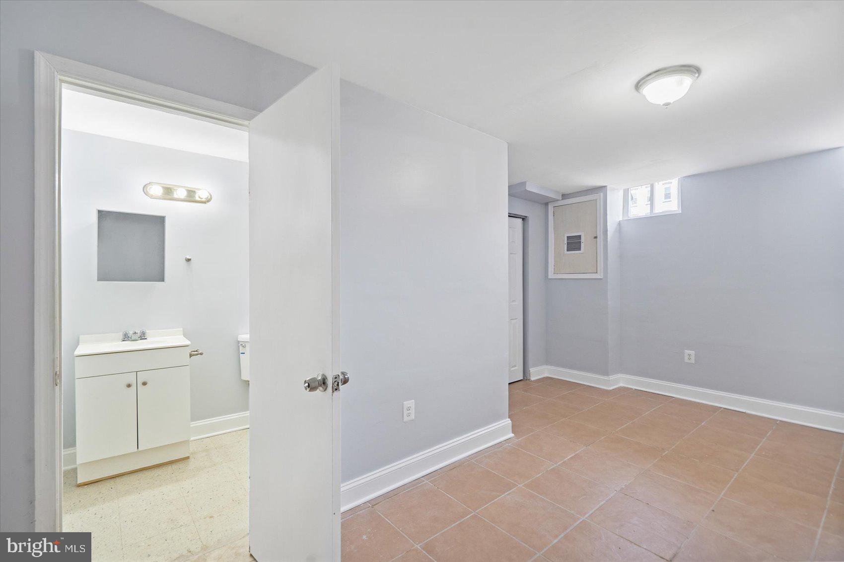 1604 North Broadway Baltimore, MD 21213 - Photo 32 of 39 a bedroom with a bed and a bathroom