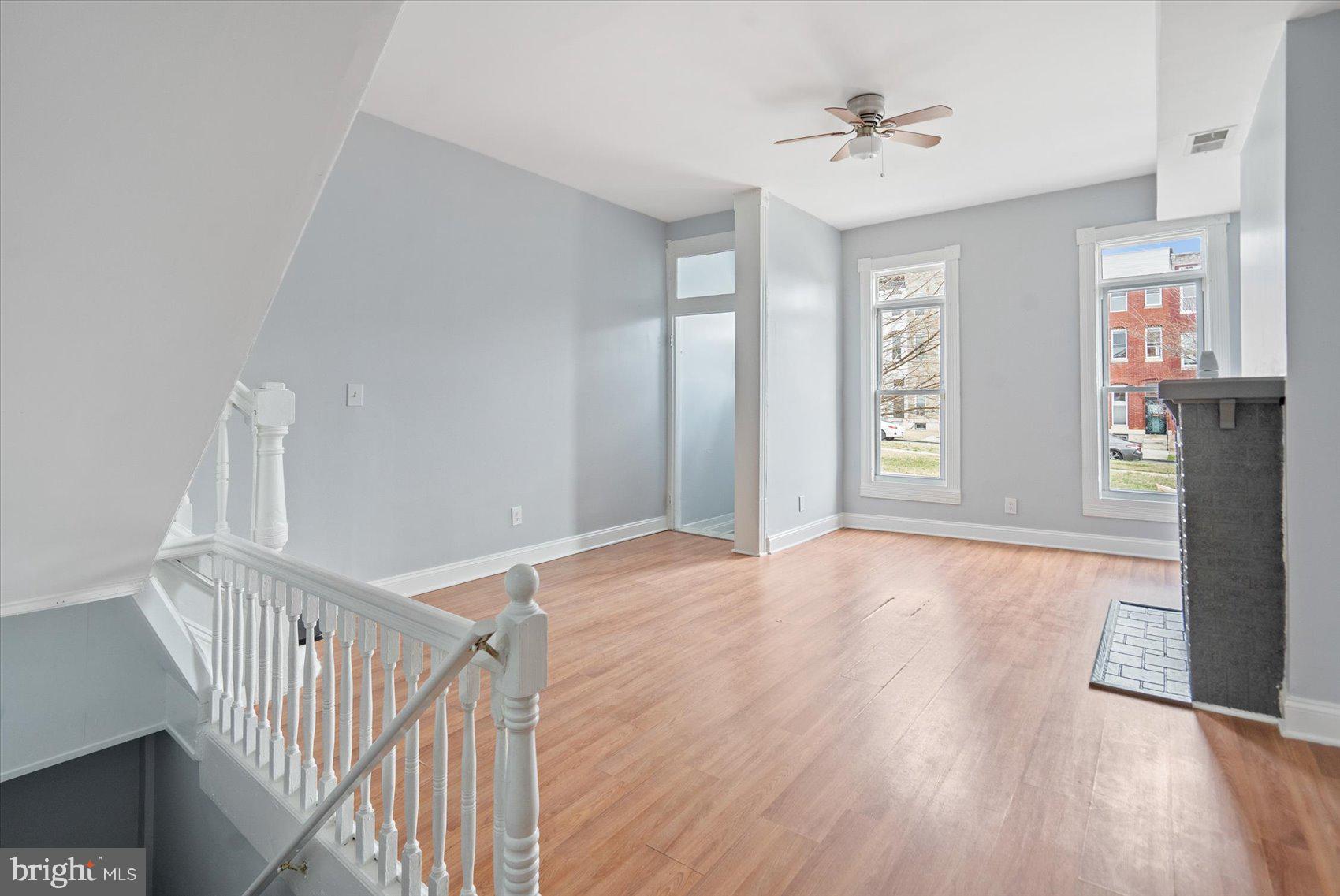 1604 North Broadway Baltimore, MD 21213 - Photo 4 of 39 a view of an empty room with a window and wooden floor