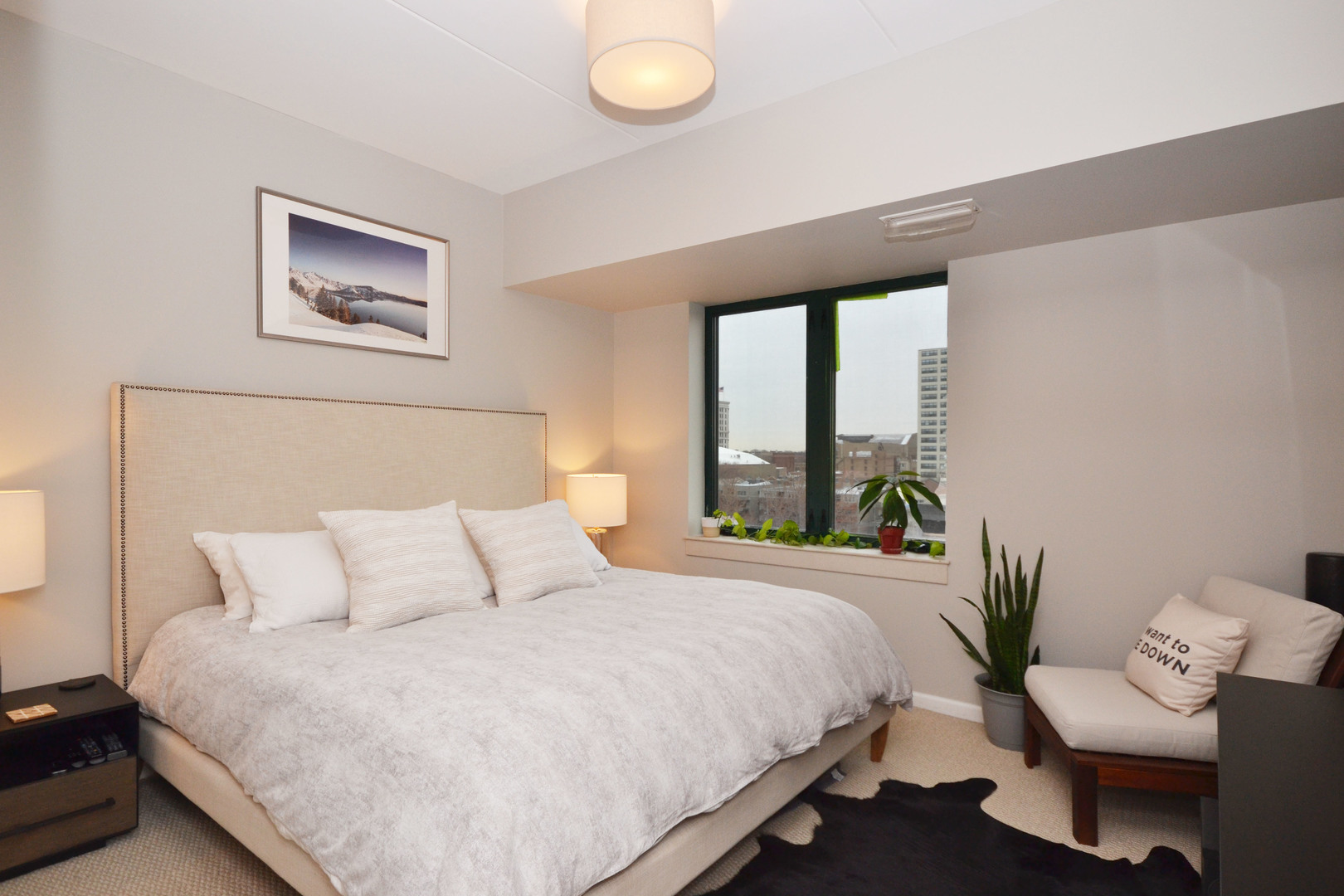 4848 North Sheridan Road, Unit 704 Chicago, IL 60640 - Photo 5 of 8 a bedroom with a large bed and a large window