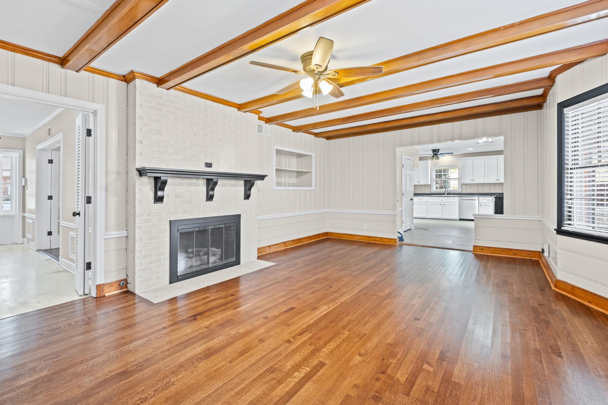 88 North Reese Street Memphis, TN 38111 - Photo 12 of 40 a view of a livingroom with wooden floor a fireplace and windows